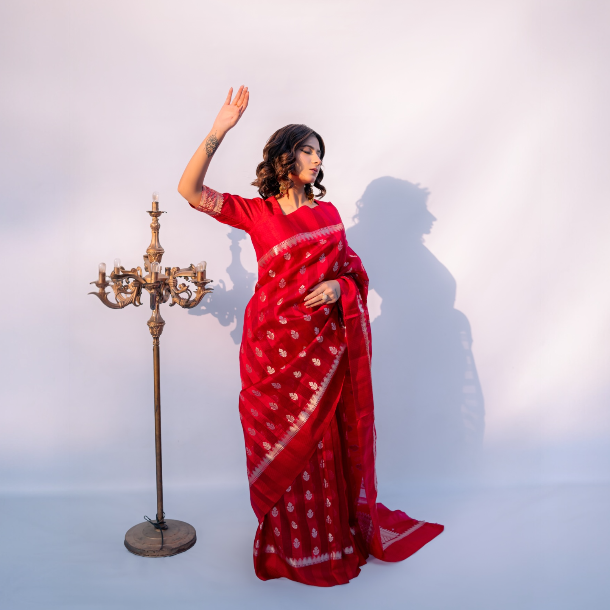 Model is wearing red banarasi saree of lunaraé london